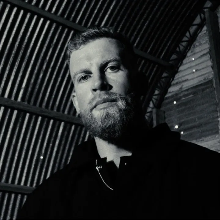 Luke-W in black and white under a corrugated metal roof
